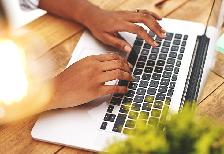 hands typing on a laptop social media marketing & management in kitsap county
